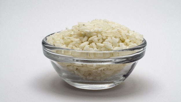 rice grains in a glass bowl on a white background