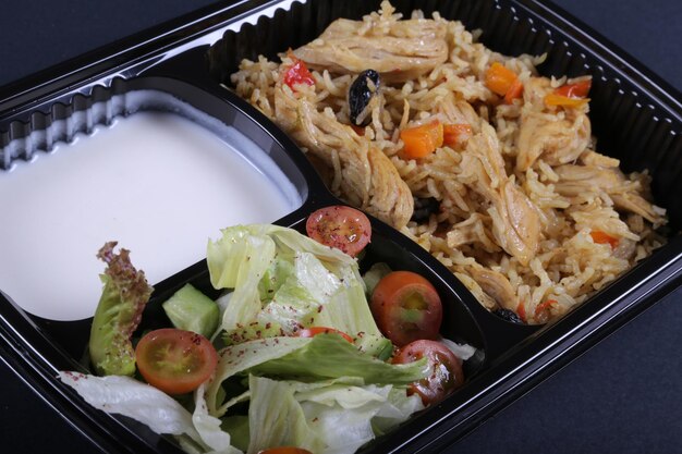 Rice meal with boiled chicken yogurt and vegetable salad Free Photo