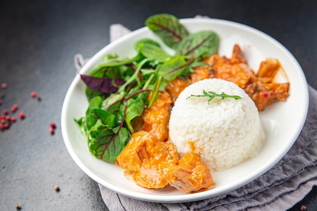 Rice meat jambalaya and salad leaves lettuce mix fresh healthy meal food snack on the table