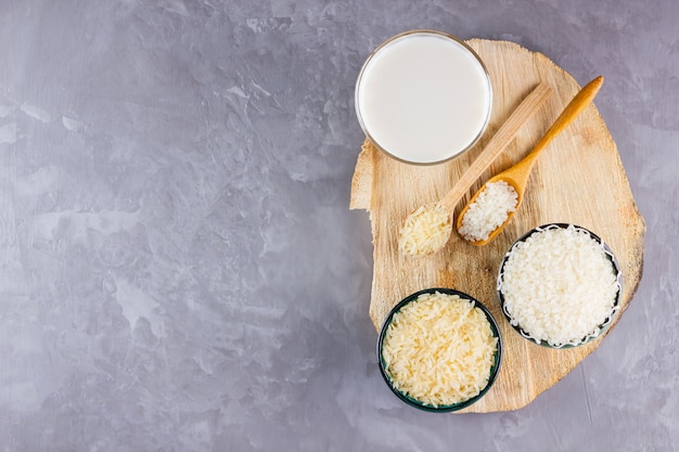 Rice milk and rice seeds on a gray background