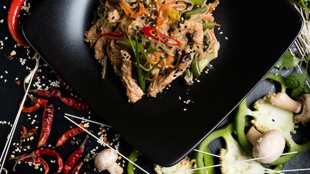 Rice noodle vegetable beef meat dish on a plate.