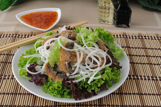 Rice noodles with mushrooms in breadcrumbs in lettuce leaves