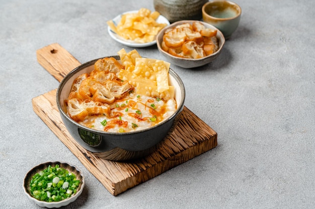 Rice porridge or congee with cakwe in bowl