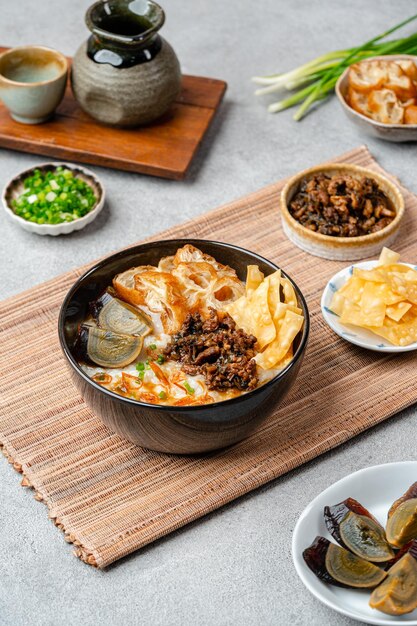 Rice porridge or congee with minced pork century egg and cakwe in bowl