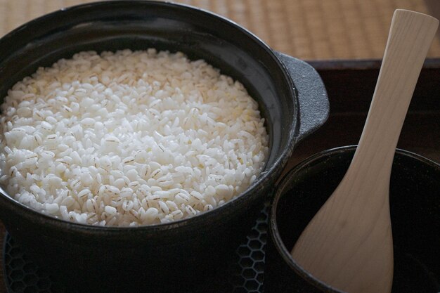 Rice in a pot and a cup of paper