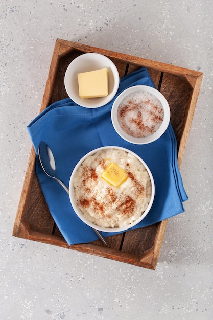 Photo rice pudding with butter cinnamon french riz au lait norwegian risgrot traditional breakfast dessert