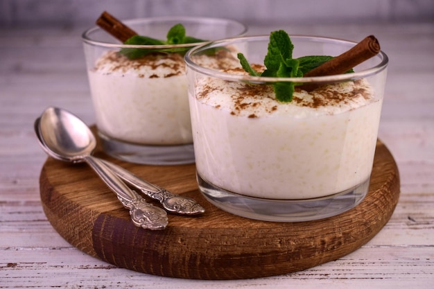 Rice pudding with cinnamon in glassesCloseup