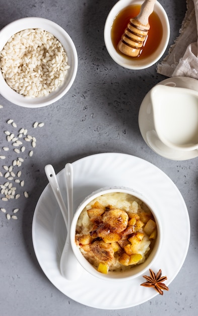 Rice pudding with fruits, honey and spices. Healthy breakfast or dessert.  