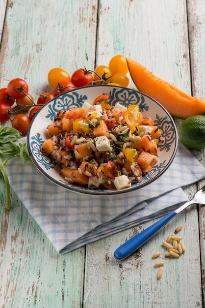 Rice salad with black rice melon mozzarella and tomatoes