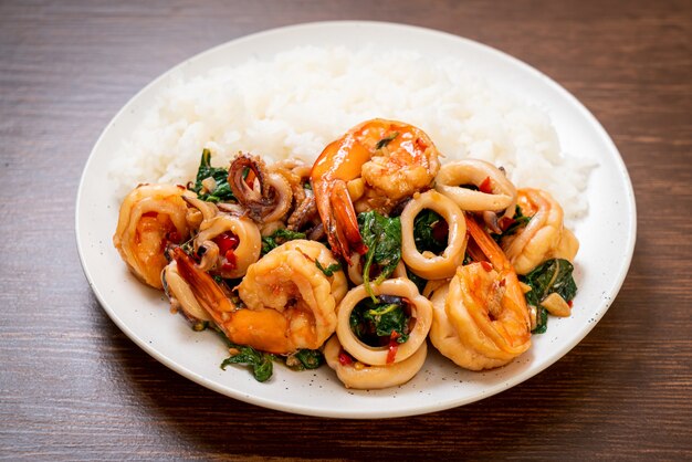 rice and stir-fried seafood (shrimps and squid) with Thai basil - Asian food style