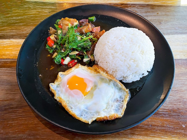 Rice topped with crispy pork belly with Thai basil and fried egg