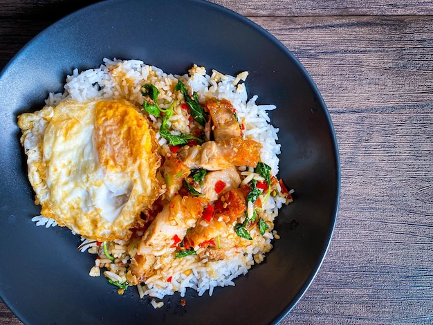 Rice topped with crispy pork belly with Thai basil and fried egg