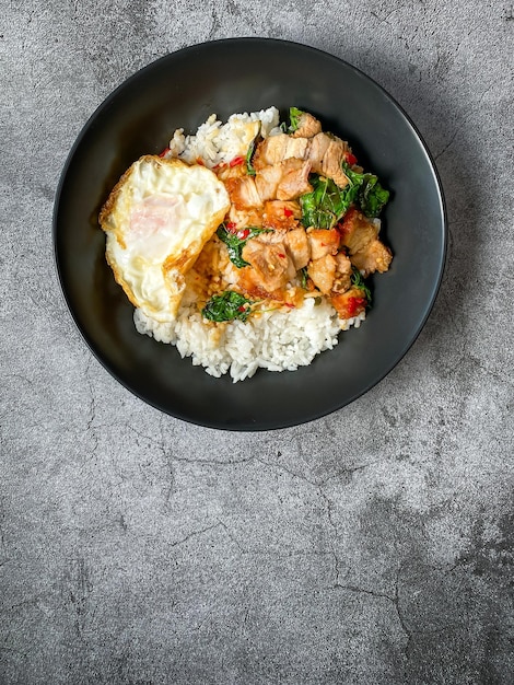 Rice topped with crispy pork belly with Thai basil and fried egg