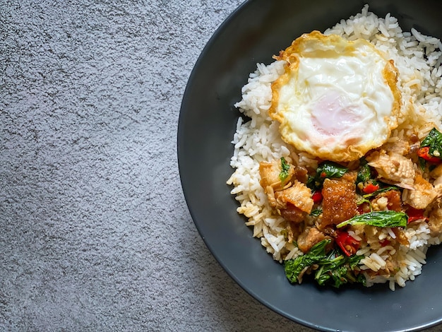 Rice topped with crispy pork belly with Thai basil and fried egg