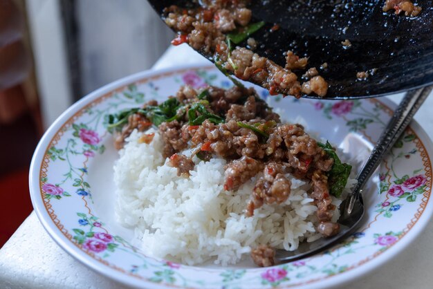 Rice topped with stirfried pork or beef and basil