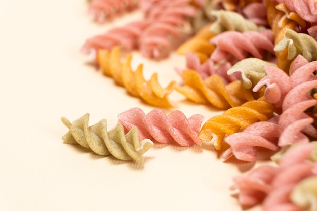 Rice vegetable pasta in the form of spirals on a white background