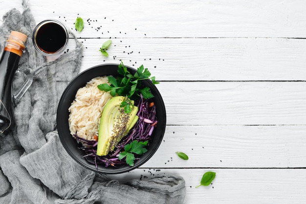 Rice with avocado and cabbage Healthy food Top view On a white wooden background Free copy space