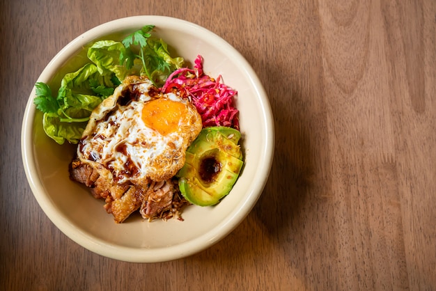 rice with fried chicken teriyaki sauce and avocado and fried egg