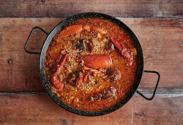 Rice with lobster on wooden background, top view