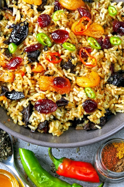 Rice with spices and dried fruits. Vegan bowl with spicy rice.