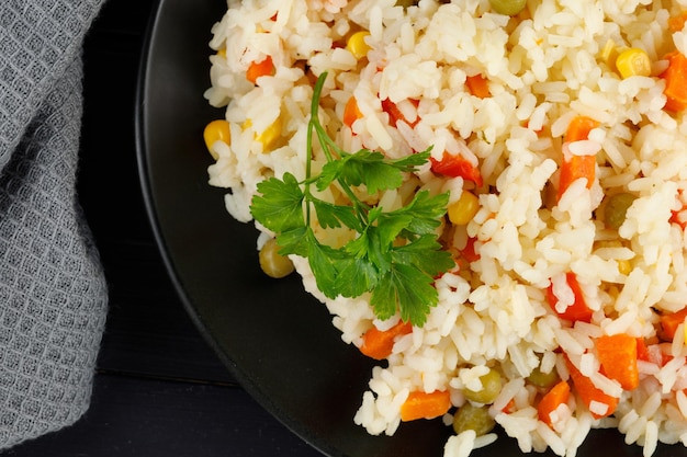 Rice with vegetables in a plate on the table