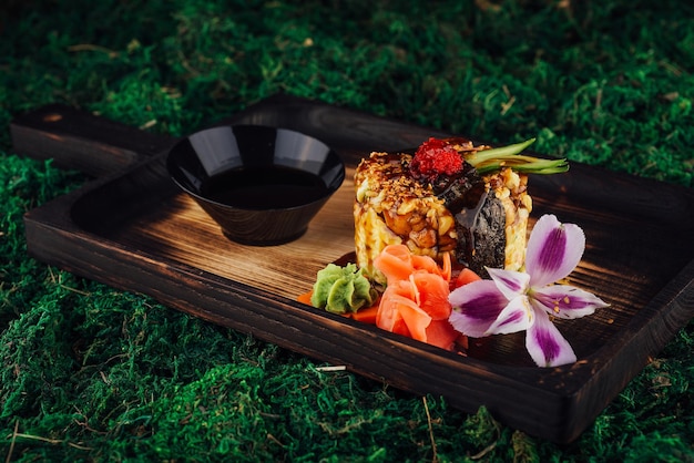 Rice with vegetables wrapped in nori and drizzled with soy sauce