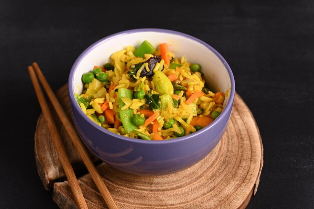 Rice with vegetables and yellow seasoning in a plate