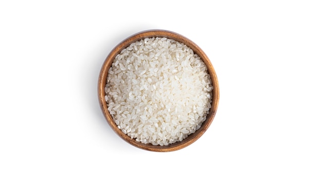 Rice in a wooden bowl isolated on a white background. High quality photo