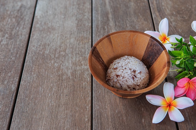 Rice in a wooden cup on a wooden floor table