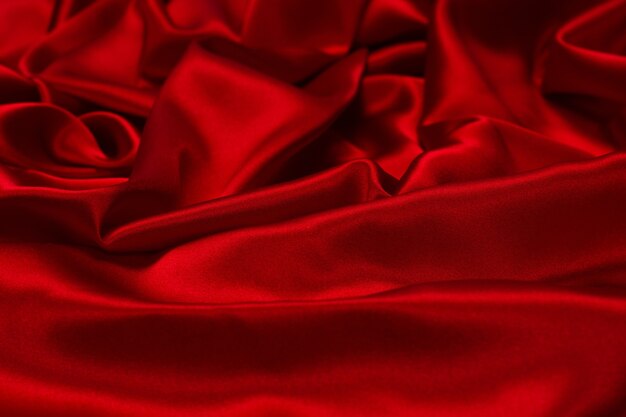 Rich and luxury red silk fabric texture background. Top view.