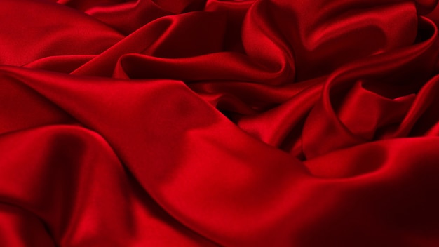 Rich and luxury red silk fabric texture background. Top view.