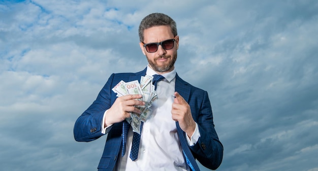 Riches of man hold money on sky background riches of man with money outdoor