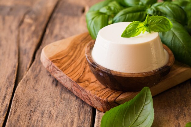 Ricotta cheese in rustic wooden bowl