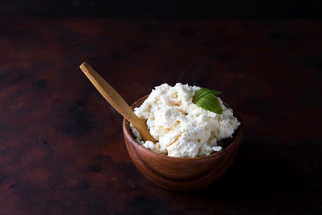 Ricotta cheese in wooden bowl