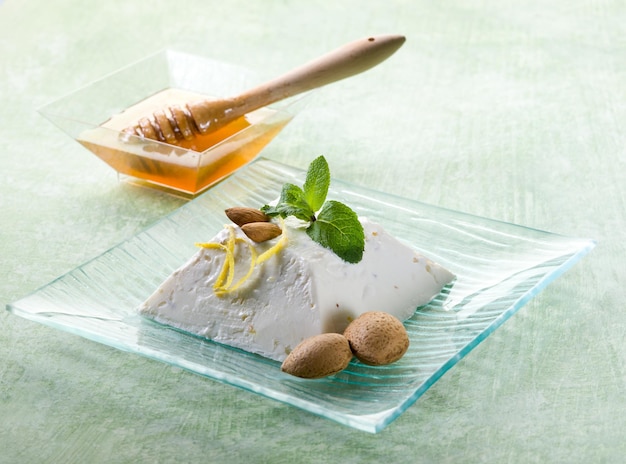 Ricotta pudding with almond honey and mint leaf