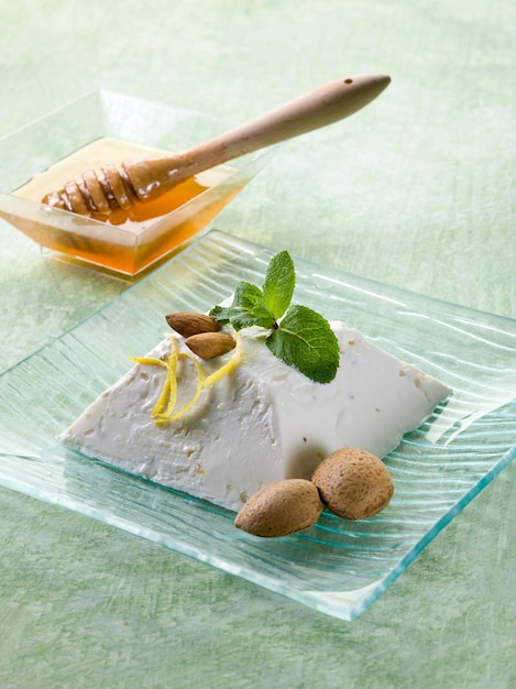 Ricotta pudding with almond honey and mint leaf