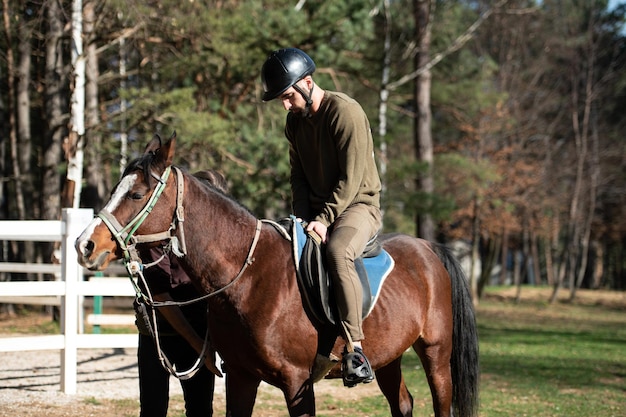 Riding man is training his horse