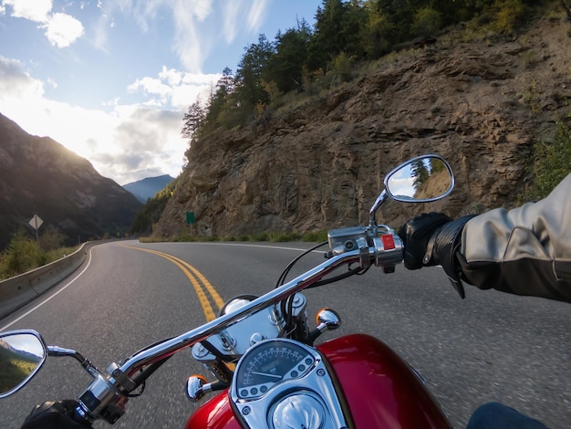 사진 캐나다 산으로 둘러싸인 경치 좋은 도로에서 오토바이 타기