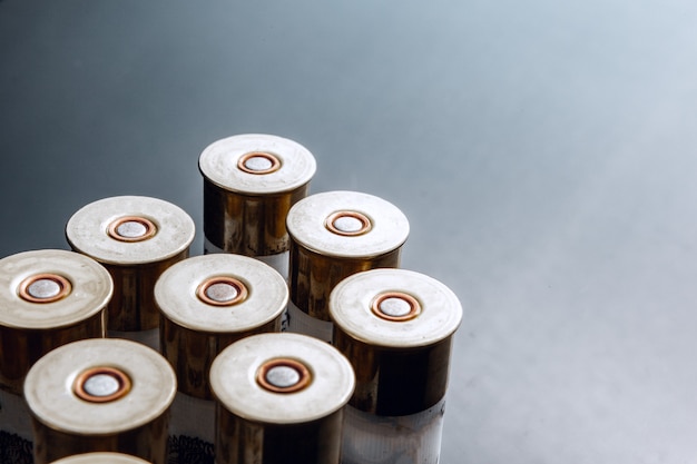 Rifle bullets or cartridges on black shiny background