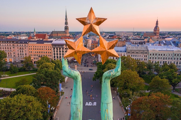 RIGA - 20 JULY, 2020: Amazing Aerial View of the Statue of Liberty Milda in Riga, Latvia during sunset. The Statue of Liberty holding Three Golden Stars