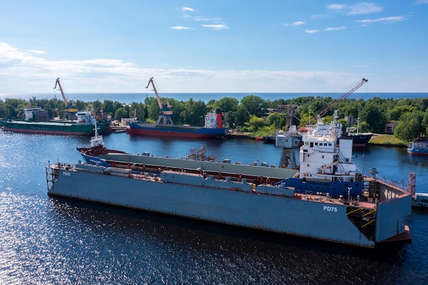 Riga Latvia June 10 2021 Cargo ship at floating dry dock is being renovated