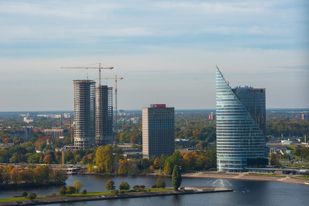 RIGA, LATVIA - OCTOBER 4 2021: An aerial view of the skyscrapers on the banks of the Western Dvina.