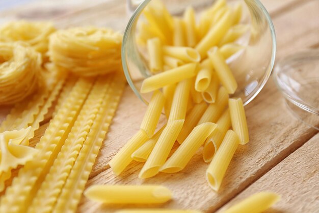 Rigate pasta on wooden table background