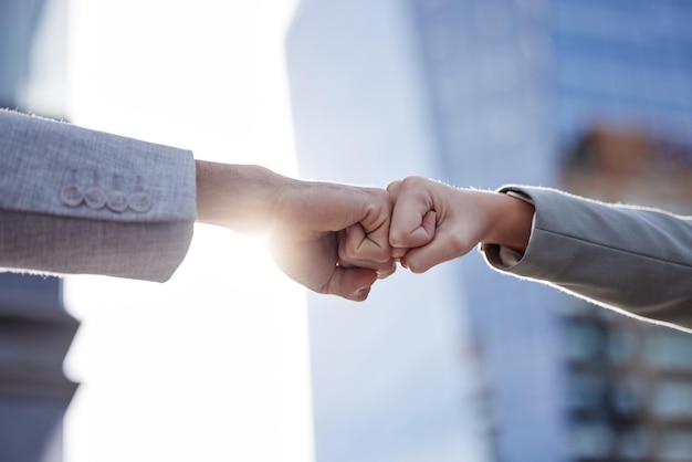 Right on the money Shot of two unrecognizable businesspeople giving a fist bump outside