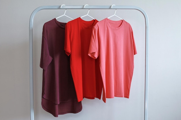 Rij van drie kleurrijke T-shirt mockup hangen op een kledingrek