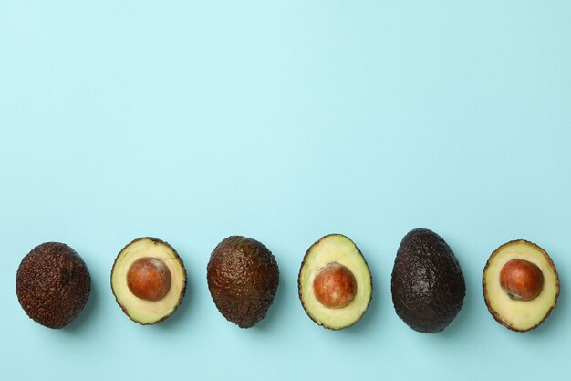 Rijpe avocado op blauwe achtergrond, ruimte voor tekst