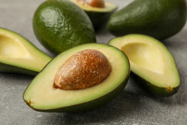 Rijpe verse avocado op grijze lijst dichte omhooggaand