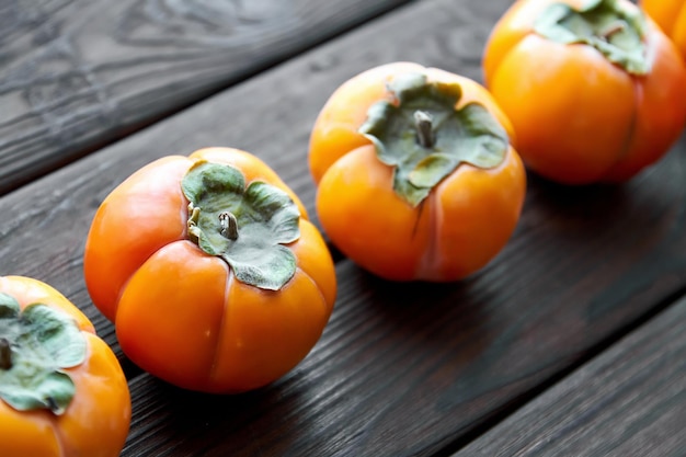 Rijpe verse persimmon op bruine houten rustieke achtergrond