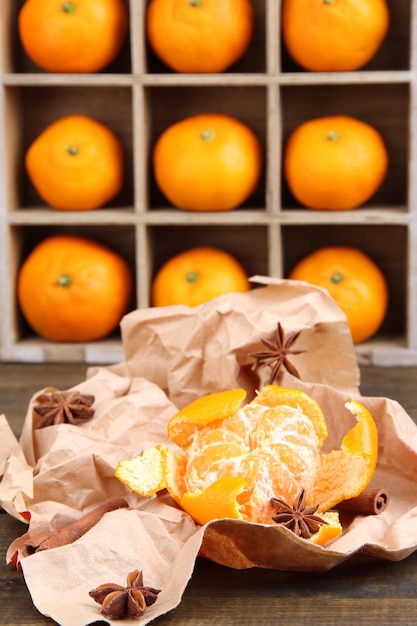 Foto rijpe zoete mandarijnen in houten boxon houten achtergrond close-up