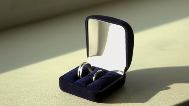Photo ring in the box on wooden table stock wedding rings in a case on the table illuminated by sunlight